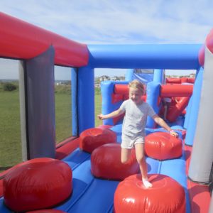 Jumping through the obstacle course in Bude during the summer holidays.